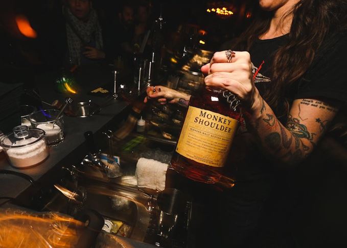 Bartender holding Monkey Shoulder blended malt whisky