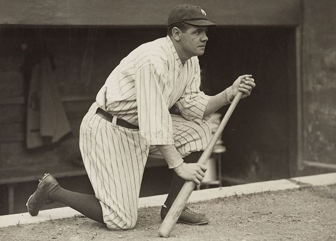 Babe Ruth kneeling with bat