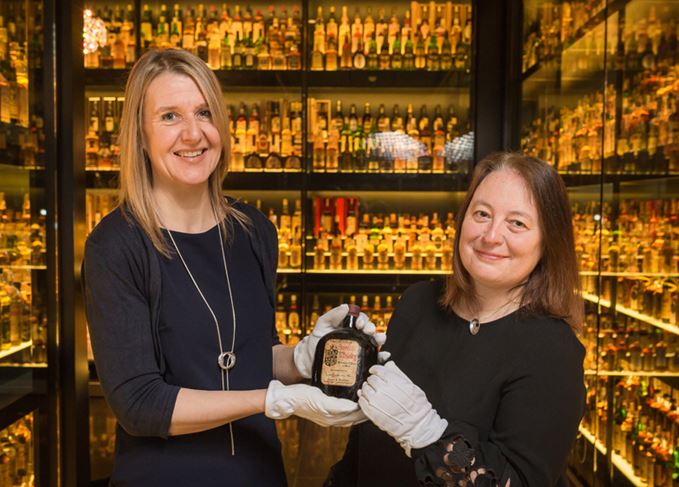 The Scotch Whisky Experience's Susan Morrison and Diageo archivist Christine McCafferty, with a Ballantine's from the Claive Vidiz Collection