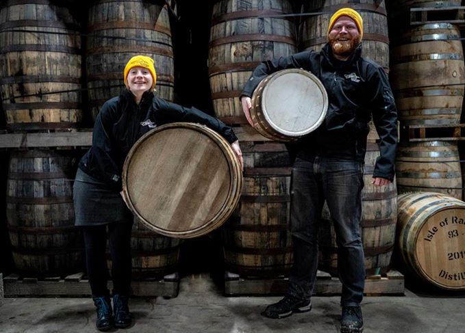 Isle of Raasay distillery staff holding 30-litre and 190-litre casks