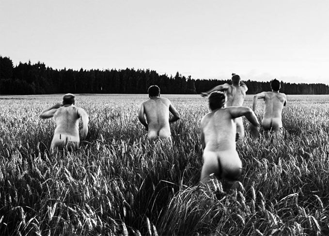 Finnish men running through a field of rye, from Kyro distillery