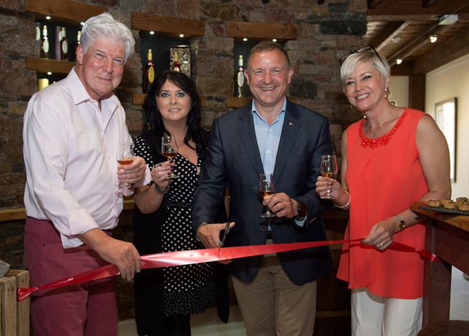 Speyside Distillers employees and Drew Hendry cutting ribbon